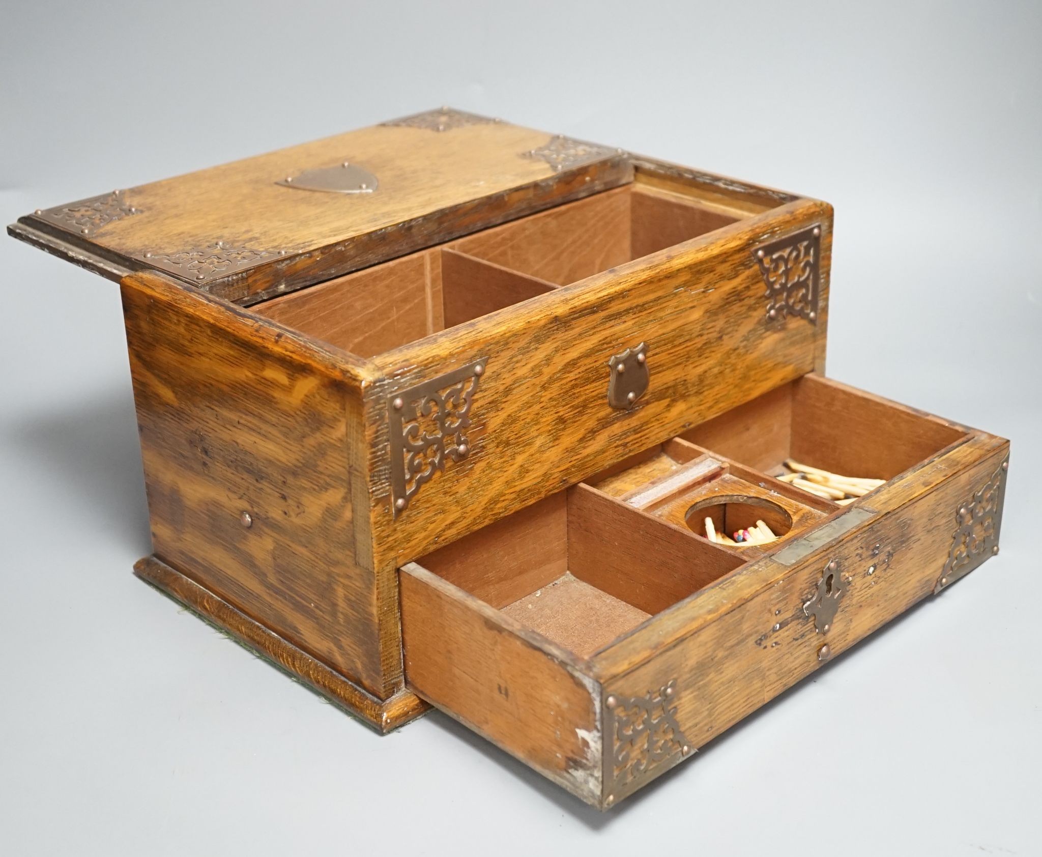 A Victorian oak smoker's box, with brass mounting, 30 cms wide x 17 cms high.